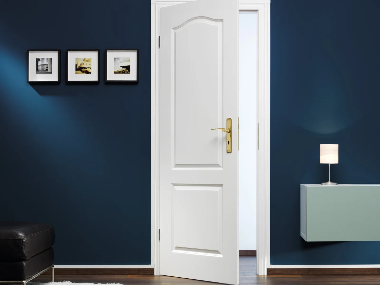 A white GGK cable channel along a dark blue wall beside a white door