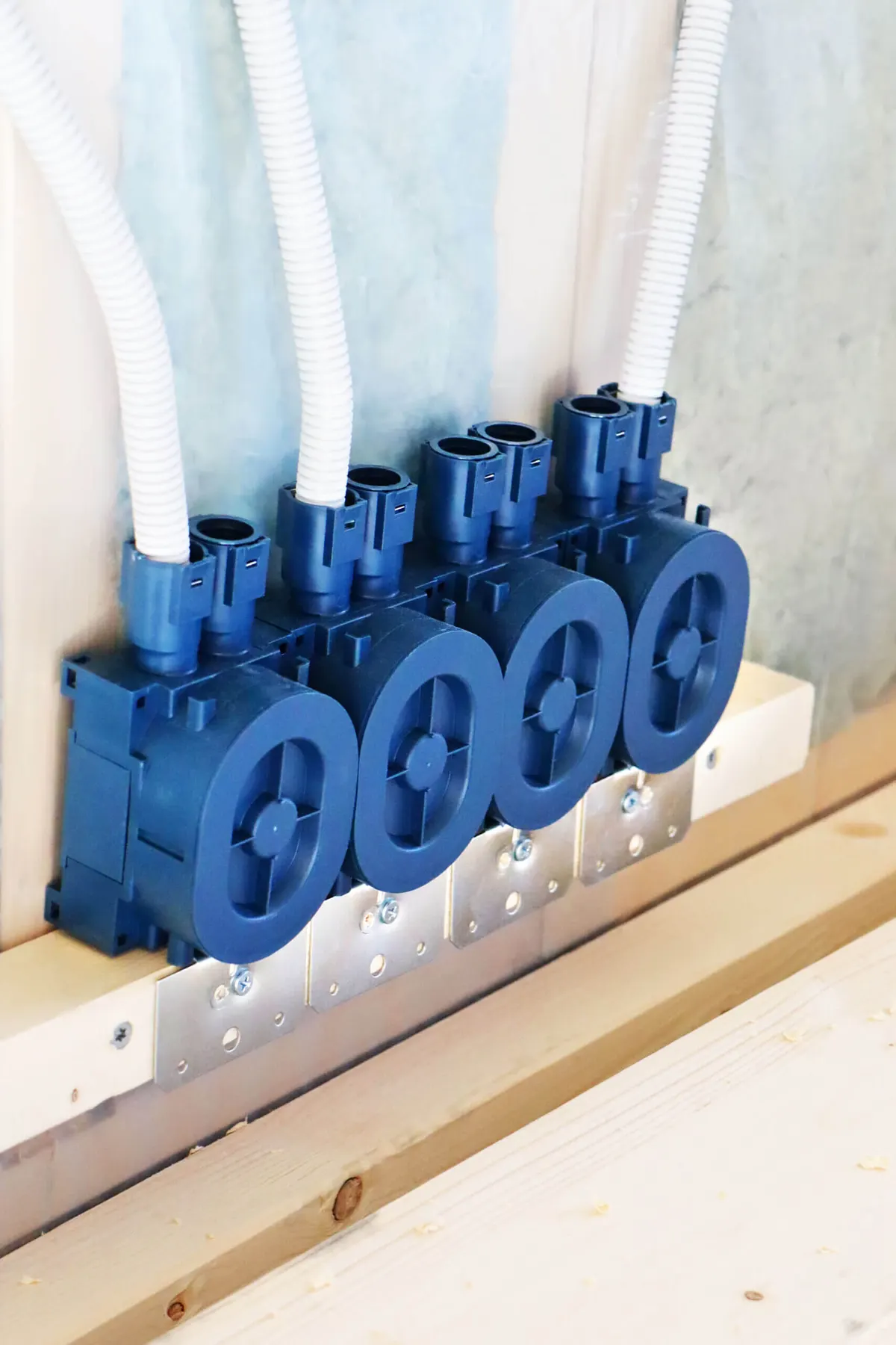 Conduits connected to a row of boxes in a timber frame