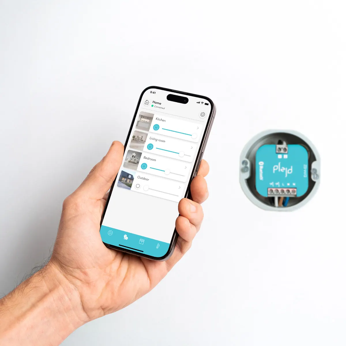 The Plejd app on a phone beside a Plejd unit