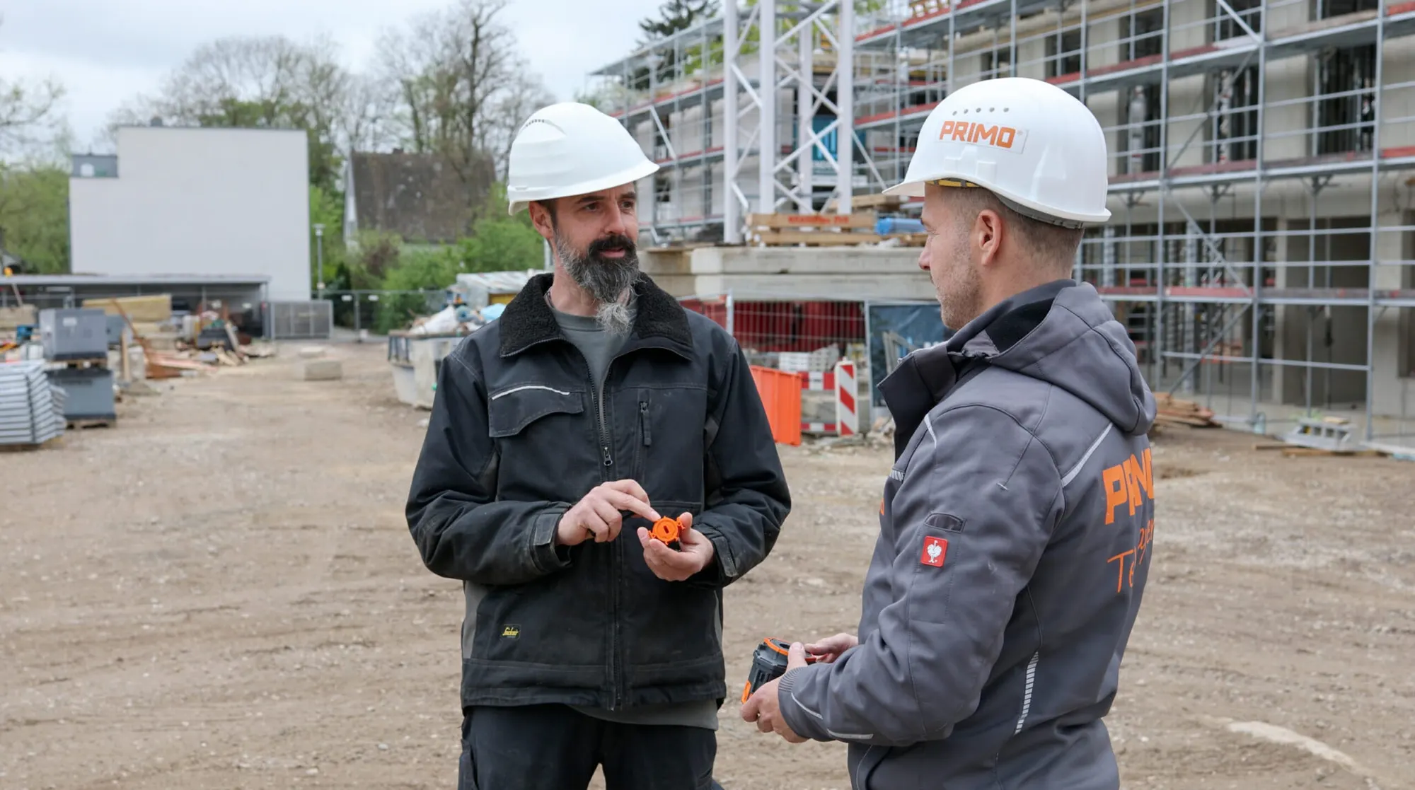 Electricians on site holding a PRIMO box