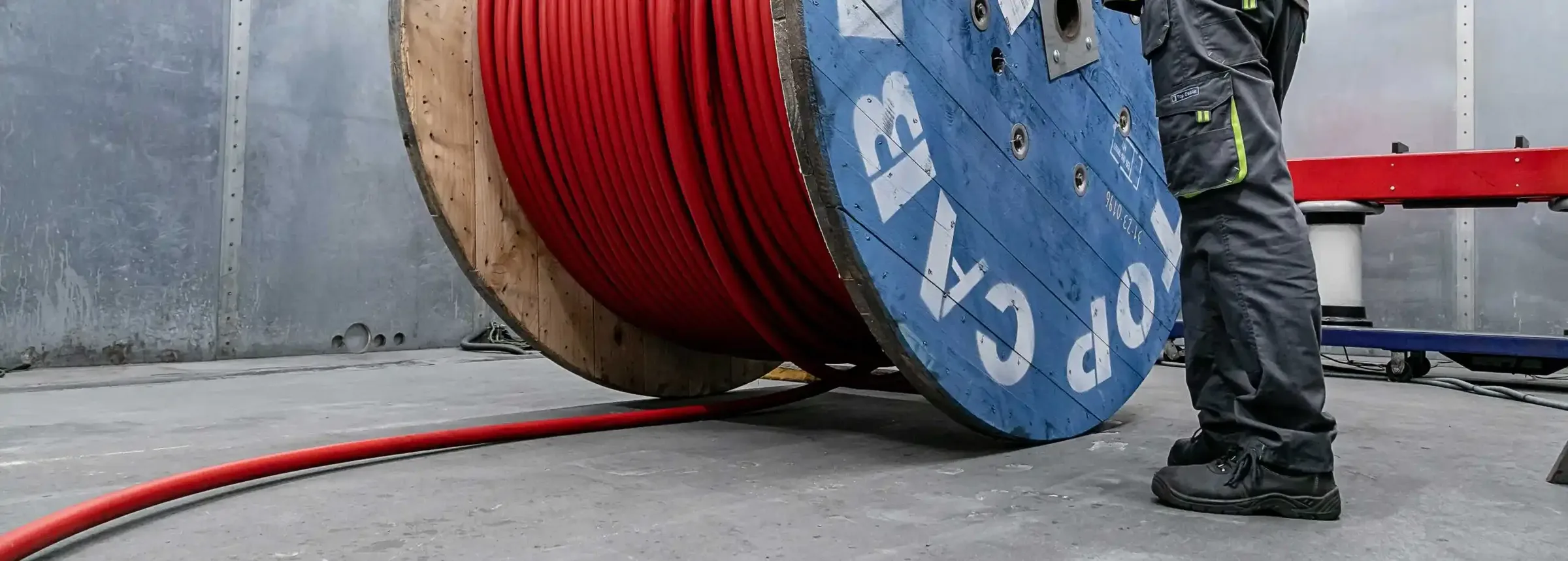 A red cable pulled off a large Top Cable reel