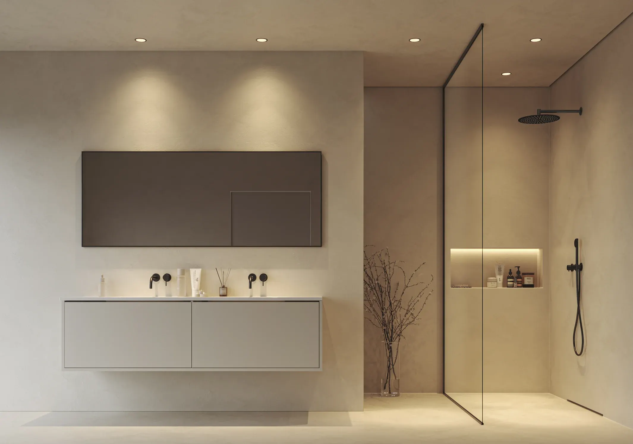 A bathroom in a light stone tone with recessed lights washing down the wall